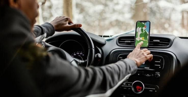 Rider using map in a car