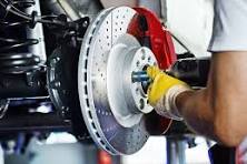 Mechanic adjusting car brakes